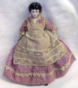 A small Frozen Charlotte Doll, porcelain painted head with moulded black hair, cloth body with