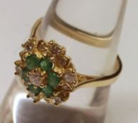 A hallmarked Gold six small Emerald and twelve small brilliant cut Diamond Ring (marks incomplete)