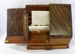 A Rosewood Effect Sloping Front Stationery Cabinet enclosing a fitted interior of letter rack etc