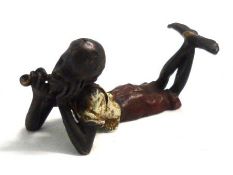 A Cold Painted Bronze Model of an African Child Smoking a Pipe, marked with a vase of flowers and