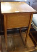 A Mahogany Worktable of square form, the top with two lifting covers inlaid with boxwood and