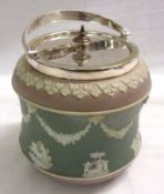 A Wedgwood Jasperware two-colour Biscuit Barrel of waisted baluster form, moulded pâte-sur-pâte in