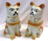A pair of large Staffordshire style Models of Cats, with treacle body markings, naturalistic faces