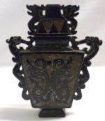 An Oriental Black Stone Covered Urn, of tapering rectangular form, applied on either side with