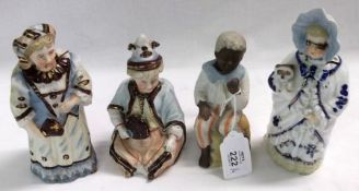 A collection of four European Nodding Figures, depicting various characters, all decorated in