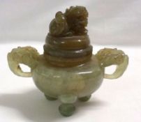 A Green Jade two-handled Covered Koro, the lid decorated with a temple dog finial and the two