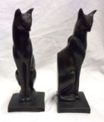 A pair of Resin Filled and Patinated Bookends, each modelled in the form of a stylised seated cat,