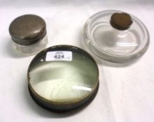 A large circular Glass Inkwell of compressed form; a further Table Top Magnifier and a base metal