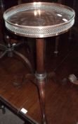 An unusual Circular Mahogany Pedestal Wine Table, applied with a silver plated galleried rim, raised
