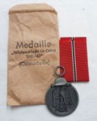 Third Reich Medal for the Winter Campaign in Russia 1941-1942, with ribbon and original printed