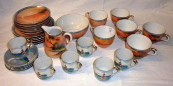 A small collection of Noritake Tea Ware, all decorated with sunrise or sunset lake scenes, below