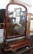 A 19th Century Mahogany Toilet Mirror, arched mirror back raised on pierced scroll moulded uprights,
