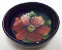 A Moorcroft small circular Bowl, the centre decorated with a clematis design on a dark blue