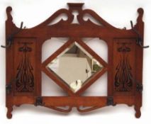 An Oak Arts & Crafts Period Wall Mounting Hat and Coat Stand, with central bevelled glass mirror