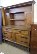 An early 20th Century Oak Dresser, in the Arts & Crafts Manner, the back with fitted plate racks and