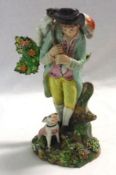 An early Staffordshire Model of a shepherd with lamb on his back and with a dog at foot, standing in