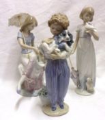 Three Lladro Models of a young girl seated under a parasol with a puppy beside her; a further