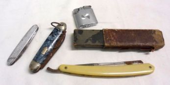 A Mixed Lot comprising: a Folding Cut-Throat Razor; a Cigarette Lighter and two Folding Pocket