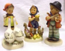 Three Hummel Figures: “Goose Girl” HUM47; “Feeding Time” HUM199; “Little Fiddler” HUM4, all 5”