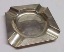 A George VI Ash Tray of square form with engine turned border and four corner rests, to a polished