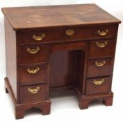 An early 18th Century Walnut Small Desk, the quarter veneered herringbone banded and crossbanded top