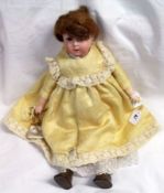 An early 20th Century Goebel Bisque Head Doll, features brown fixed glass eyes, painted lashes and