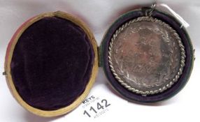 An early 19th Century Silver Plated on Copper School Medallion, engraved “At Misses Atkins