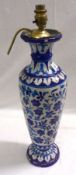 An Eastern Pottery Table Lamp, decorated in shades of blue with a floral and geometric design (