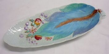 A Clarice Cliff single-handled oval Cucumber Dish moulded with fruit and foliage, decorated in