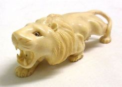 An Oriental Ivory Model of a rampant lion in crouching position, 5” long