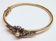 An Edwardian style tubular yellow metal Bangle, featuring a front panel set with small rose-cut