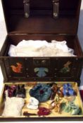 A Small Trunk containing a quantity of Vintage mostly White Ware Dolls Clothing, to include a