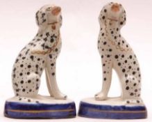 A pair of 19th Century Staffordshire Models of seated Dalmatians, each with naturalistic faces,