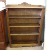 An Oak Arts & Crafts Period Freestanding Bookcase, the top with a slightly raised pediment with