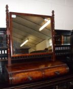 An early 19th Century Mahogany Toilet Mirror, with rectangular mirror back, raised on ring turned