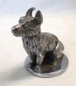 A Chrome Plated Car Mascot, modelled in the form of a seated terrier, on a polished circular base,