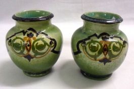 A pair of English Pottery Baluster Vases, decorated in green, ochre and black on a speckled green