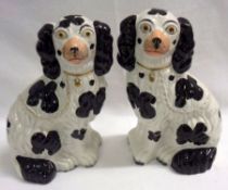 A pair of late 19th Century Staffordshire Models of seated dogs, faces with naturalistic detail,