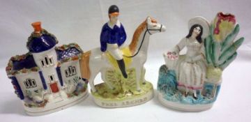 A Staffordshire Model of a cottage; a further Spill Vase Model of a seated lady flower-seller; and a