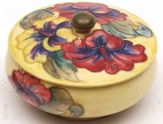 A Moorcroft circular Covered Powder Bowl, decorated with a hibiscus design on a lemon ground,