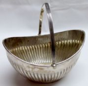 An early 20th Century Silver Swing-Handled Sugar Basket, of oval form with half-fluted body, applied