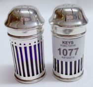 Two George V Pepper Casters, each of cylindrical form with pierced pull-off covers and further