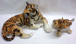 Two Russian Models of a reclining tiger and a seated cub, 7” and 5” high