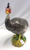 A European Model of a guinea fowl, with black body markings and further naturalistic painted detail,