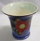 A Royal Doulton Trumpet Vase, brightly decorated in colours with a stylised floral design on a