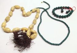A packet containing a Green Bead Necklace and Bracelet; together with an Oriental Engraved Oval Bone