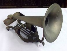 An early 20th Century Phonograph, with spring-loaded clockwork mechanism, raised on iron lyre base