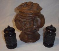 An unusual Oriental Hardwood Covered Spice Jar, of baluster form, heavily carved and moulded with