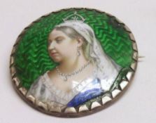 A large late Victorian white metal framed Circular Brooch with enamelled portrait of Queen