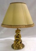 A 20th Century Gilt Metal Table Lamp, applied with an earlier figure of a seated putto, 18” high